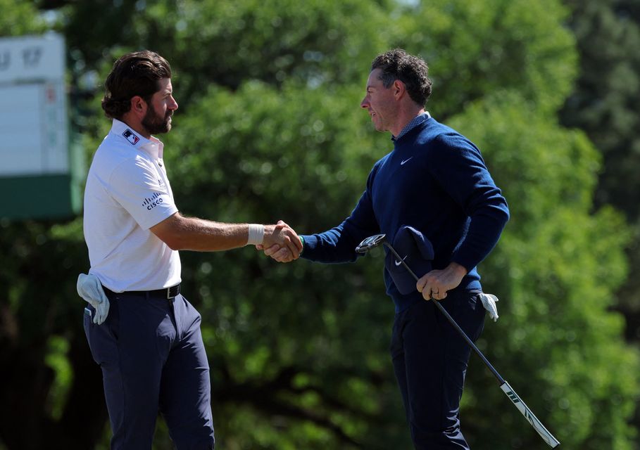 Rory McIlroy shakes hands with Cameron Young